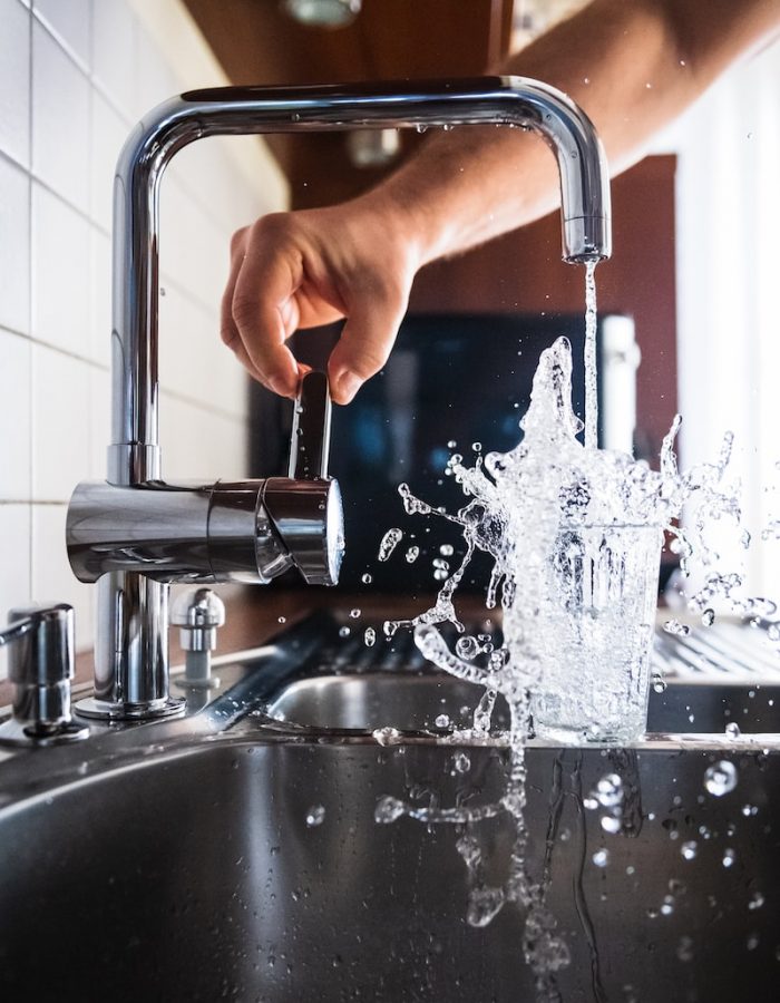 person opening faucet